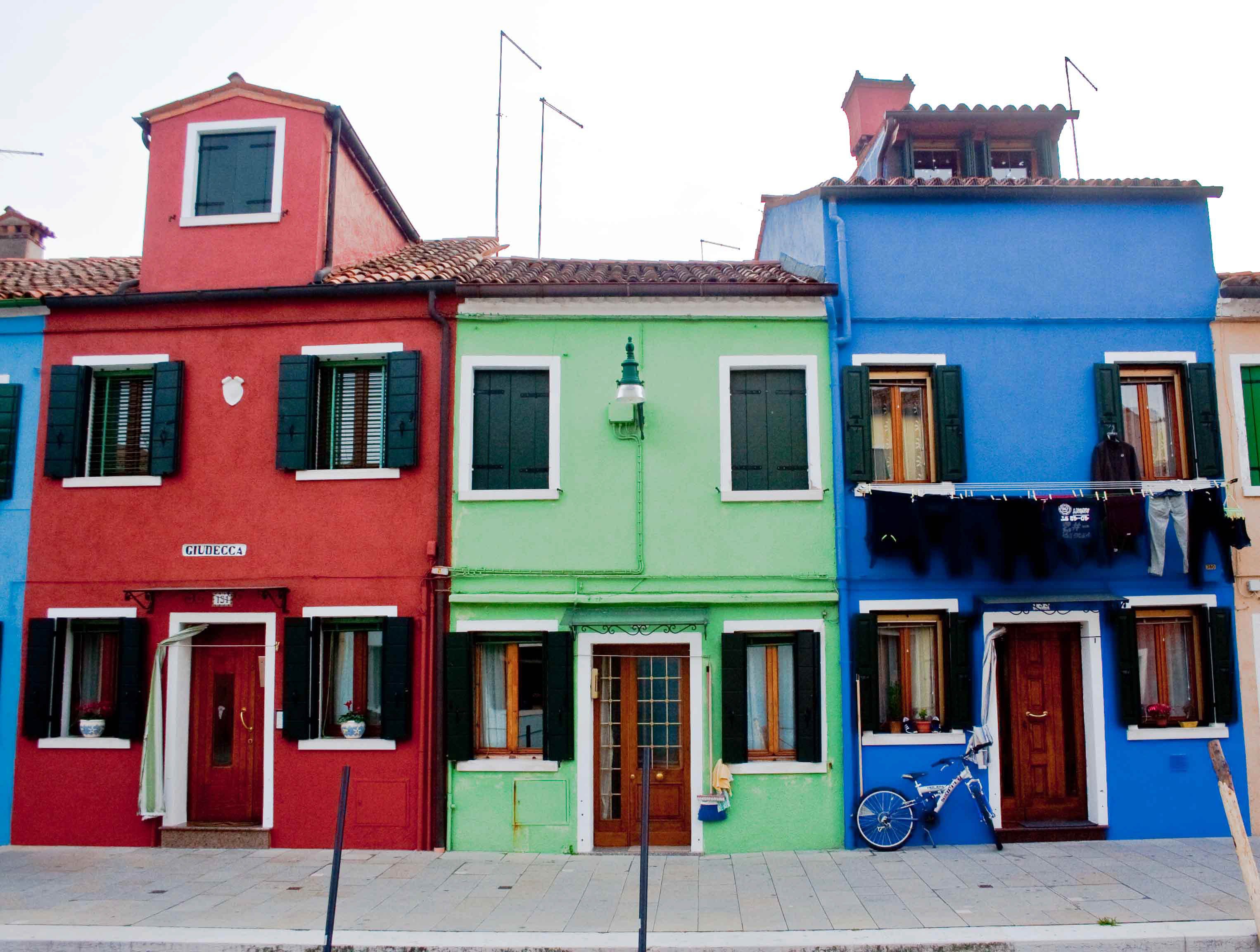 Rows of colour-washed houses along a canal in Burano
